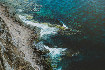 Aerial view of rocky coastline and turquoise sea water