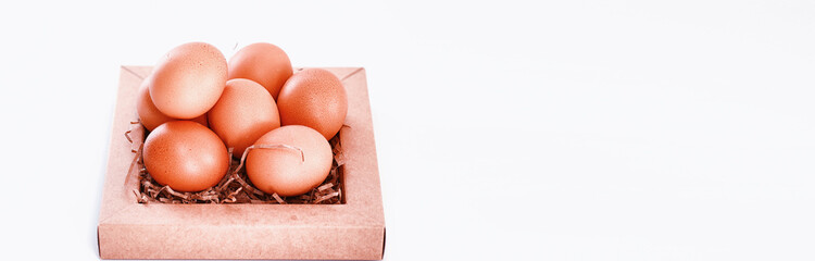 Chicken brown eggs on a white table