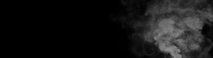 White smoke on a black background. Texture of smoke. Clubs of white smoke on a dark background for an overlay