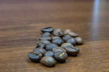 Coffee beans scattered on a wooden table