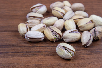 Salted pistachios on a wooden table close-up