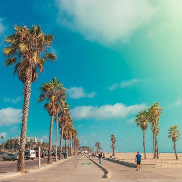 Boardwalk of Venince beach with palms vintage toned image, Los Angeles, USA