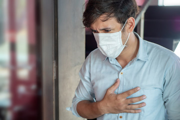 man wearing air filter mask having Dyspnea, breathing difficulty, respiratory distress in unhealthy, danger, polluted air environment - obrazy, fototapety, plakaty