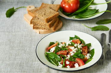 Tomato salad with sorrel and cottage cheese in a white bowl