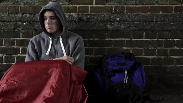Vulnerable Homeless Teenage Boy Sleeping On The Street