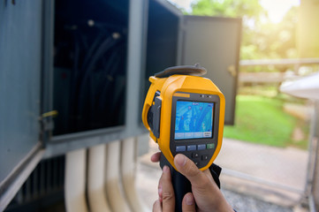 Technician use the thermoscan to check temperature in transformer