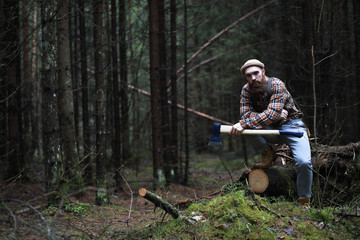 Naklejka premium A bearded lumberjack with a large ax