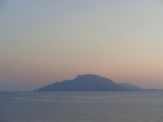 Fototapeta premium view to a rock at sunset over the ocean at summer