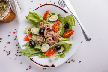 Fresh salad with iceberg lettuce,tomatoes,eggs,canned tuna and olives