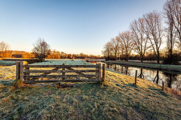 Closed wooden gate in a Dutch winter landscape