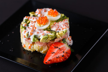 Round salad made of red fish potato and avocado