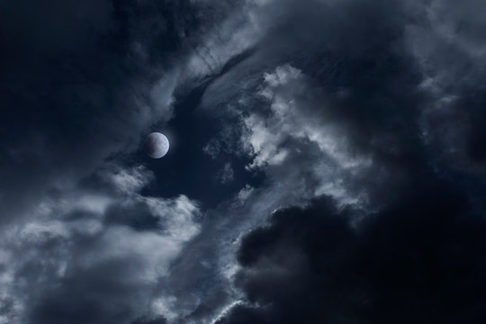 dark night sky with moon and clouds, mysterious horror background