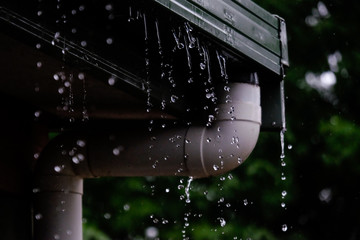 Overflowing Gutter During a Summer Rainshower