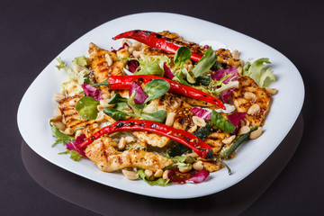 Mexican salad with hot pepper chiken fillet lettuce on plate