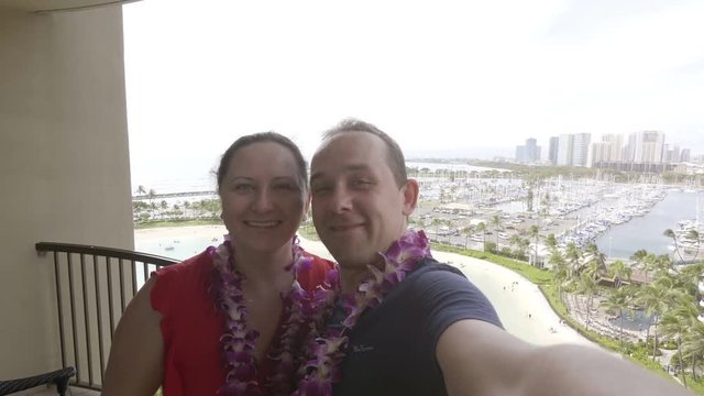 Happy couple taking a selfie at Waikiki beach in Honolulu Hawaii in 4k slow motion  60fps
