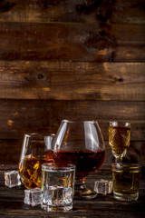 Assortment various hard and strong alcoholic drinks in different glasses: vodka, cognac, tequila,...