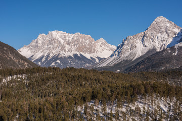 Germany highest mountain the Zugspitze..In winter, the mountain is full of beauty, with many trees in the valley and snow on top of the mountain.