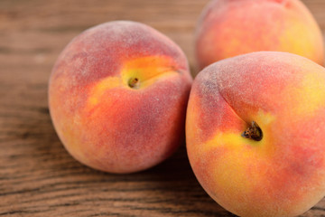 Fototapeta na wymiar whole ripe peach on wooden background