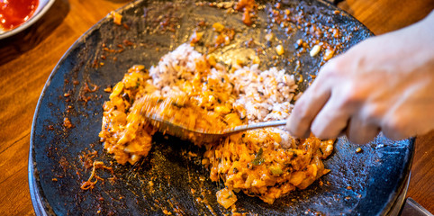 Delicious volcanic shaped fried rice with egg and spicy sauce, pork and squid, famous south korean food in jeju island restaurant, close up