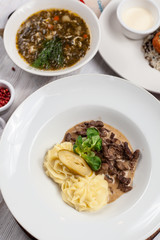 Traditional hot beef stroganoff with fluffy mashed potatoes and parsley as a part of set menu
