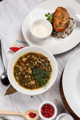 Hot rustic sorrel soup as a part of diet set menu in a restaurant