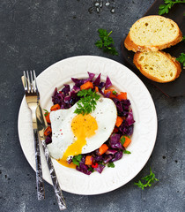 Fried eggs with warm salad of red cabbage and pumpkin.