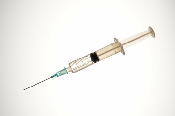 Syringe with medicinal solution, on light background with reflection. 2 ml syringe macro close up
