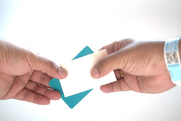 Hand with paper wristband and hold card payment