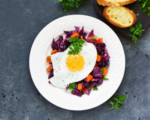 Fried eggs with warm salad of red cabbage and pumpkin.