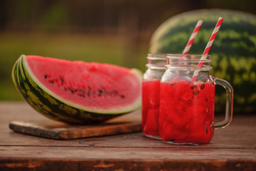 Watermelon smoothies and watermelon sliced ripe on wooden table.