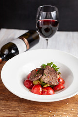 Mini bbq pork steaks with mashed potatoes and fragrant tomatoes, served with red wine