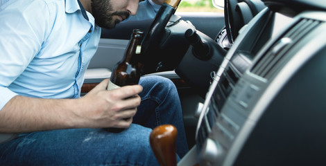 Drunk young man driving a car; sleeping,