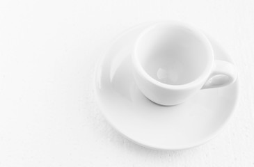 closeup top view on white coffee cup and saucer, empty coffee-free coffee cup, for black coffee, on a white background