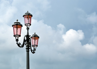 Fototapeta na wymiar old street lamp on background of blue sky