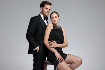 Hopeful young man standing behind his seated girlfriend