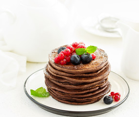 Chocolate pancakes with berries.