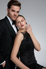 Beautiful girlfriend looking sideways and leaning on her boyfriend