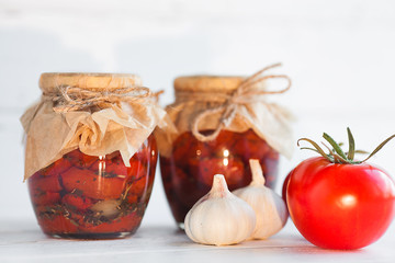 Tomatoes in the jar. Homemade sun dried tomatoes. temporary closing-down. Summer and autumn canned food. conserve with spices and vegetables.