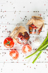 Sun dried tomato top view. Flat lay shot of jar with homemade conservation. Preserve with tomatoes. Italian spices for pizza.