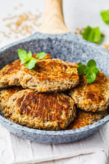 Lentil patties in gray frying pan. Healthy vegan food concept.
