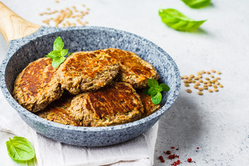 Lentil cutlets in gray frying pan. Healthy vegan food concept.