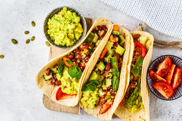 Vegan tortillas with quinoa, asparagus, beans, vegetables and guacamole. - obrazy, fototapety, plakaty
