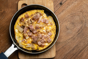 Fried egg with beacon in little pan view from top close up macro shot