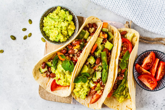 Vegan tortillas with quinoa, asparagus, beans, vegetables and guacamole.