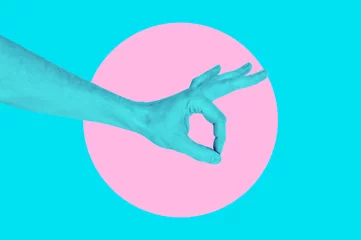  Isolated on blue background painted man hand photo on pink circle. Surrealistic collage style, contemporary art element for design, posters and banners. Cotton candy pop colors. Magazine style © Katia