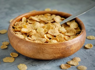 Crunchy fitness flakes. Healthy breakfast. Wooden dishes