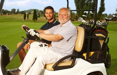 Happy golfers in golf cart