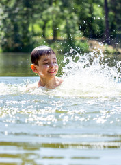 boy of seven years swimming in the lake