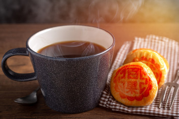 hot coffee and Moon Cake pastry dessert.