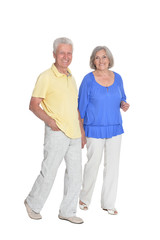 Full length portrait of senior couple holding hands isolated